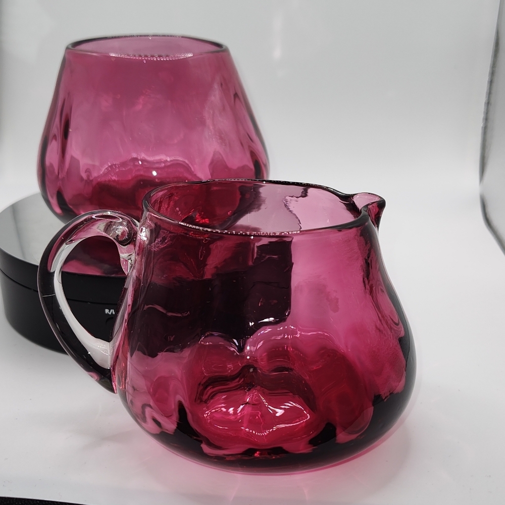 Ruby colored blown glass creamer and sugar.